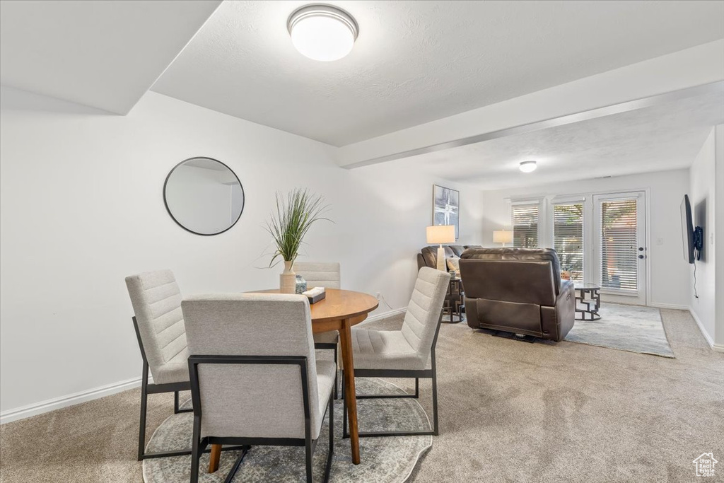 Dining room featuring carpet floors and baseboards