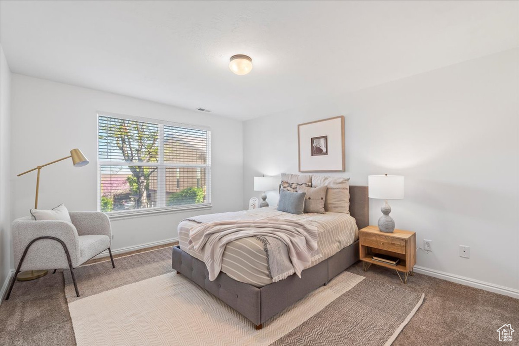 Bedroom with baseboards and carpet