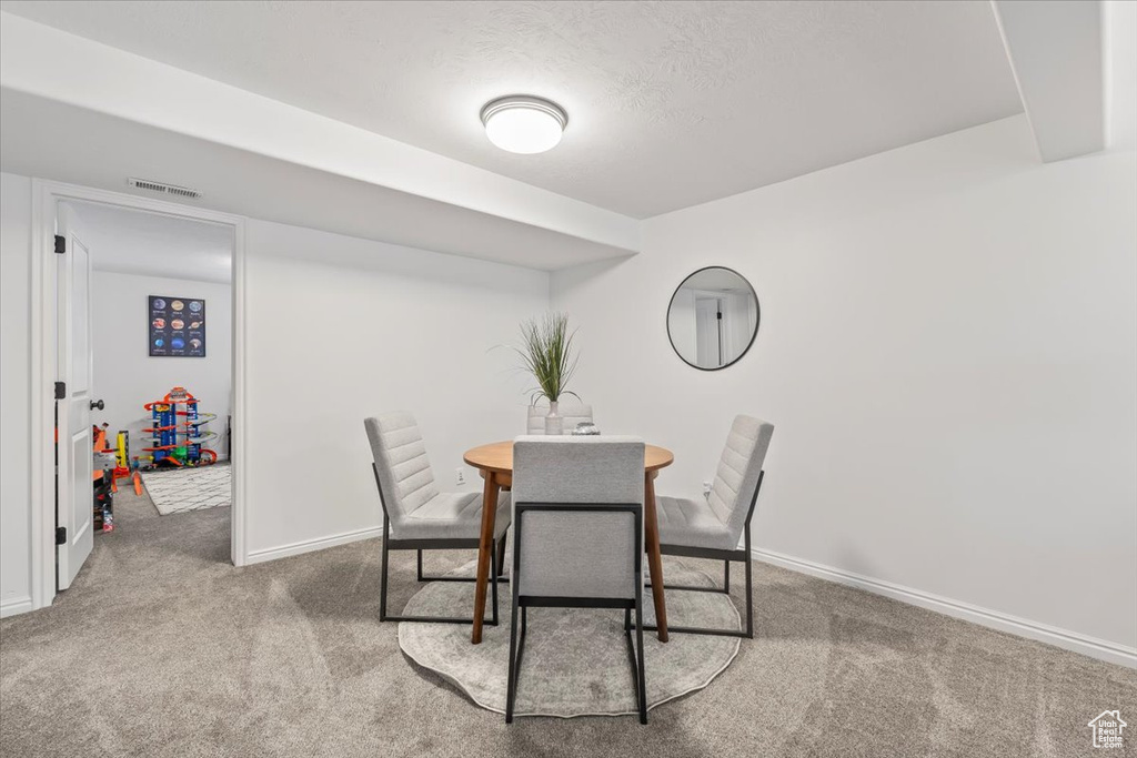 Dining room featuring baseboards, carpet flooring, and visible vents