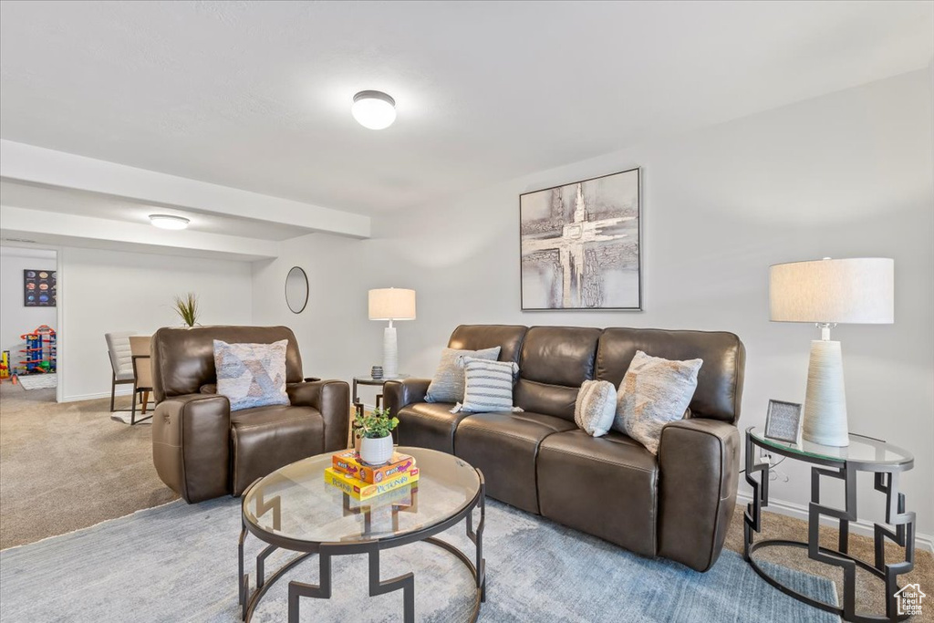Carpeted living area featuring baseboards
