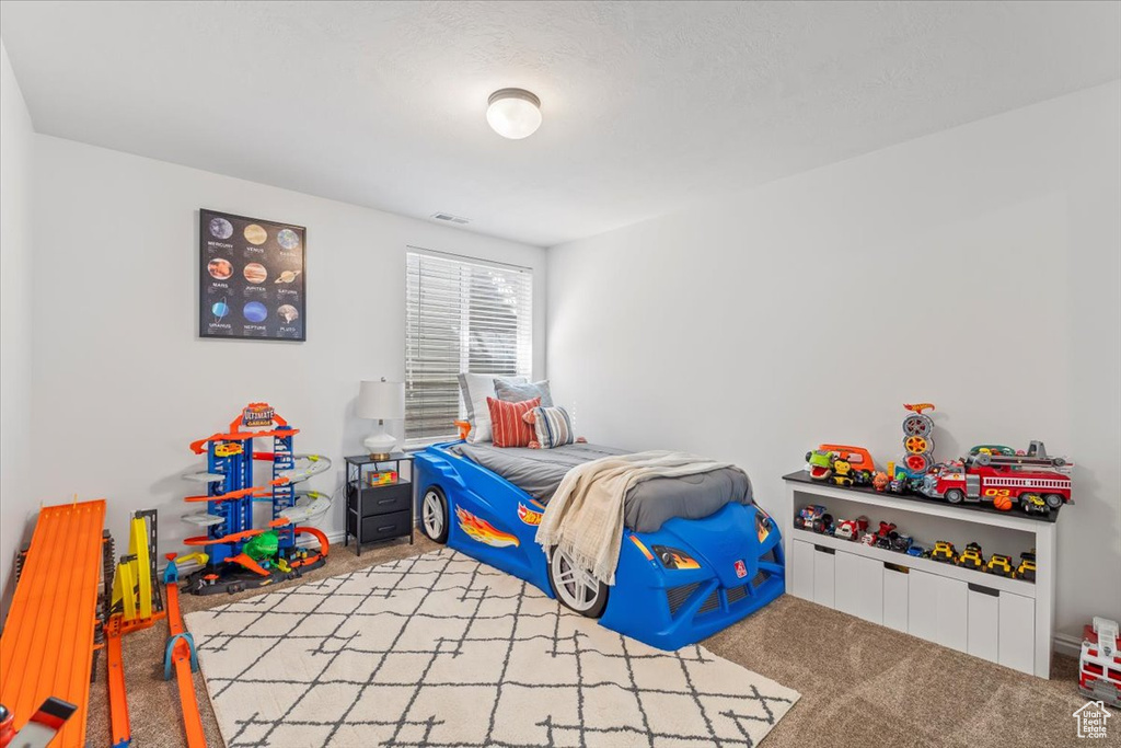 Bedroom featuring visible vents and carpet