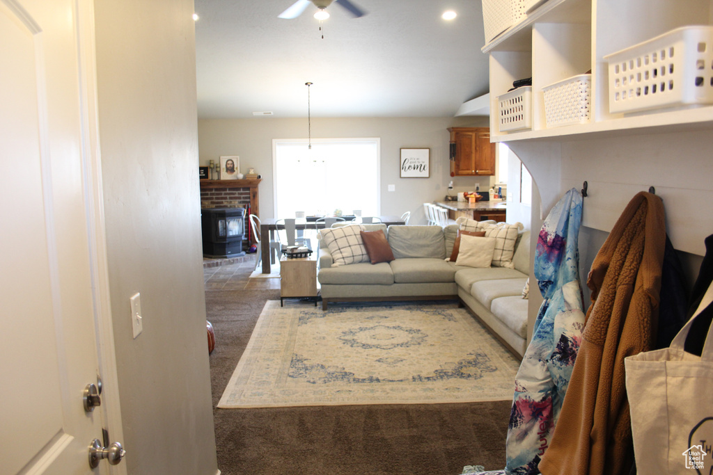 Carpeted living area with a ceiling fan