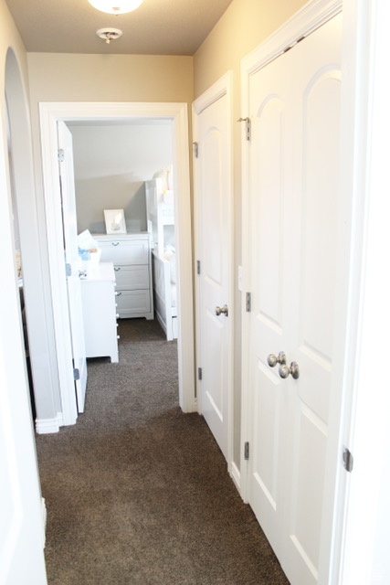 Hall with dark colored carpet