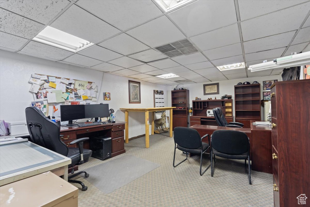 Office with carpet, a paneled ceiling, and visible vents