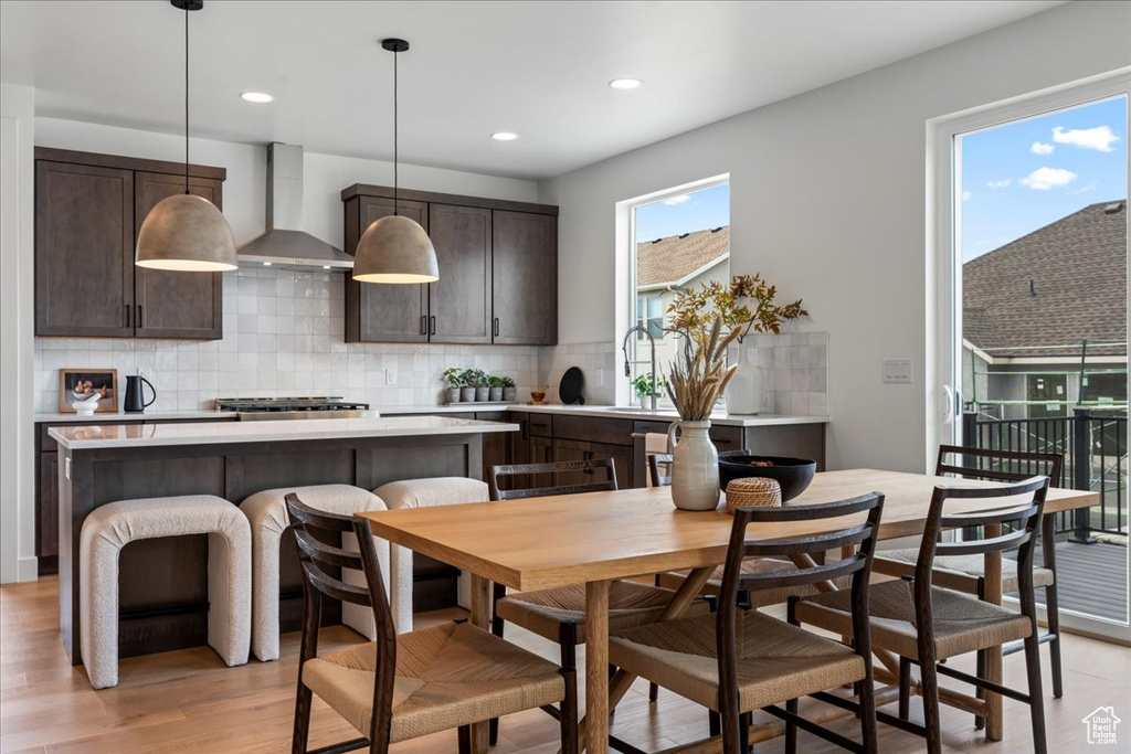 Dining space with light wood-type flooring and recessed lighting