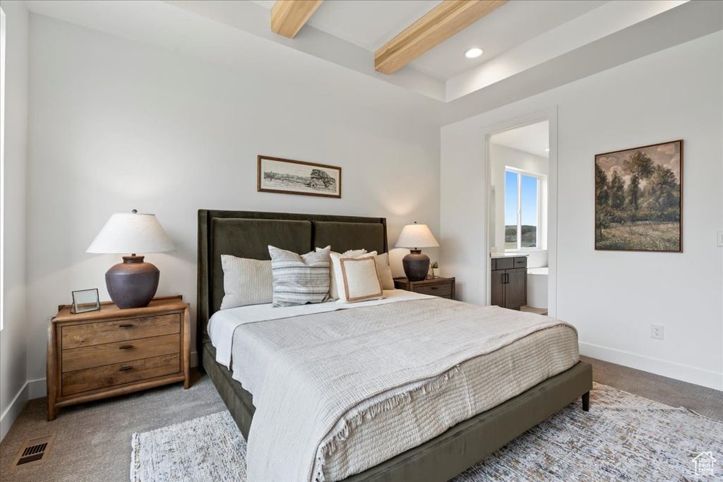 Carpeted bedroom with connected bathroom, beam ceiling, recessed lighting, baseboards, and visible vents
