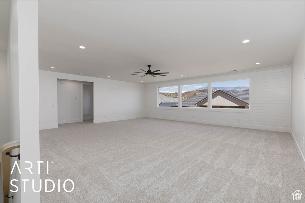 Spare room with light colored carpet, a ceiling fan, recessed lighting, and baseboards