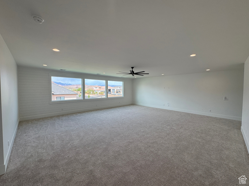 Spare room featuring carpet floors, baseboards, a ceiling fan, and recessed lighting