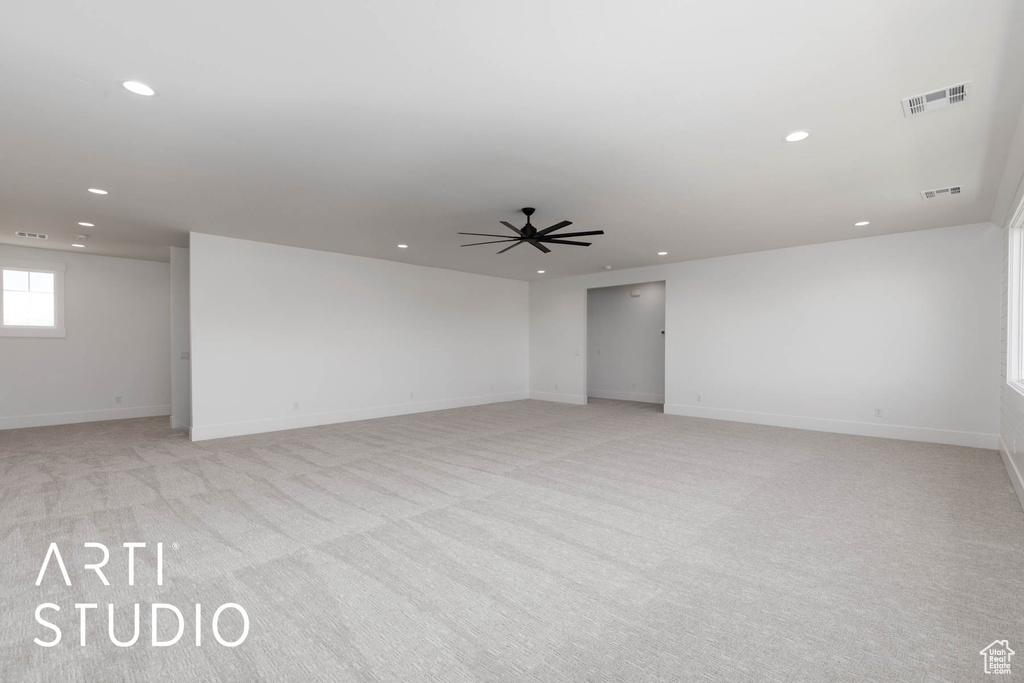 Spare room featuring recessed lighting, light colored carpet, baseboards, and ceiling fan