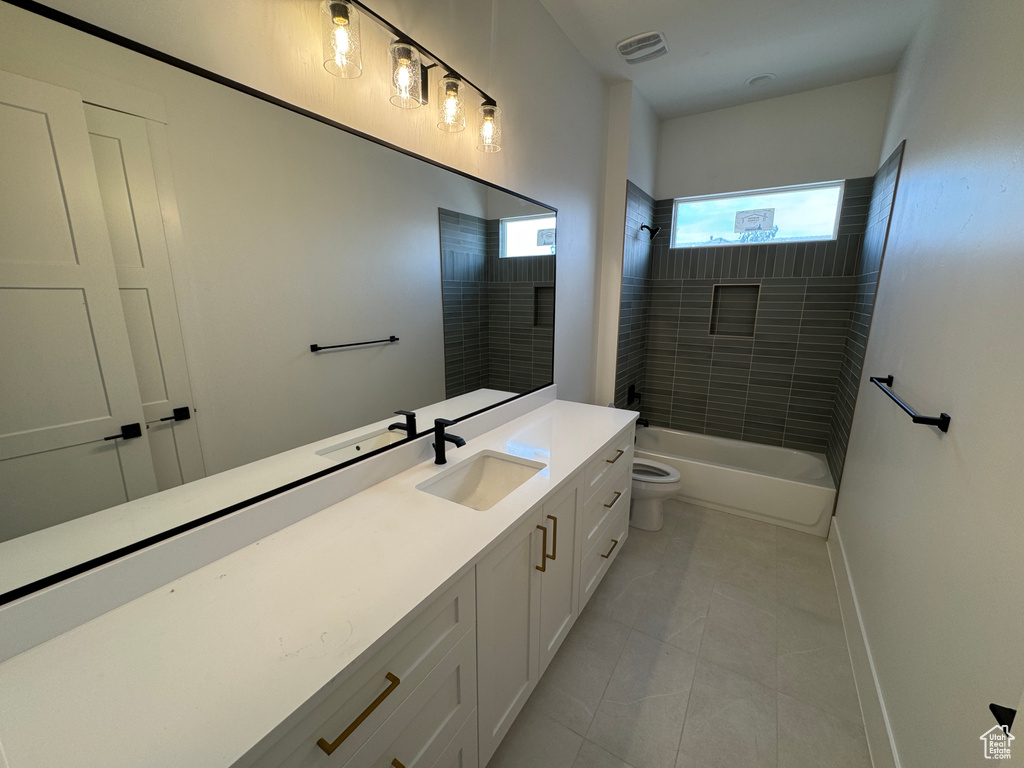 Full bath featuring vanity, visible vents, toilet, tile patterned floors, and shower / bath combination