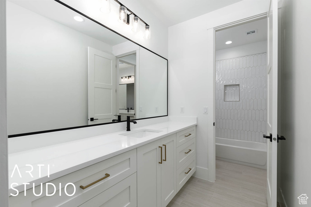 Full bath with vanity, recessed lighting, and tub / shower combination