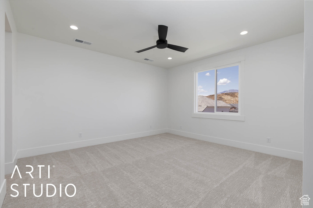 Carpeted empty room with baseboards, ceiling fan, and recessed lighting