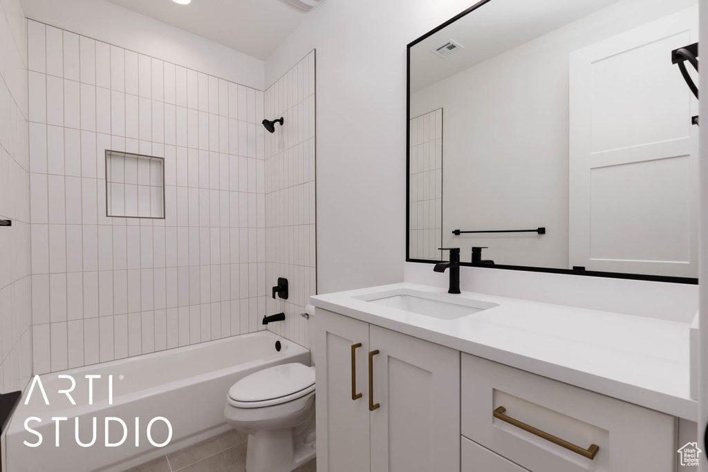 Full bath featuring toilet, vanity, washtub / shower combination, and tile patterned flooring