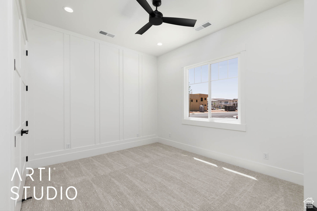 Carpeted empty room featuring a ceiling fan, baseboards, and recessed lighting