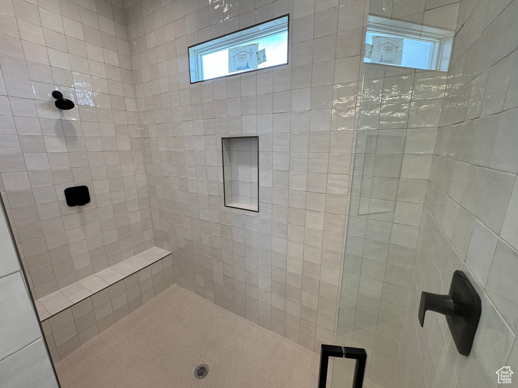 Bathroom with plenty of natural light and a tile shower