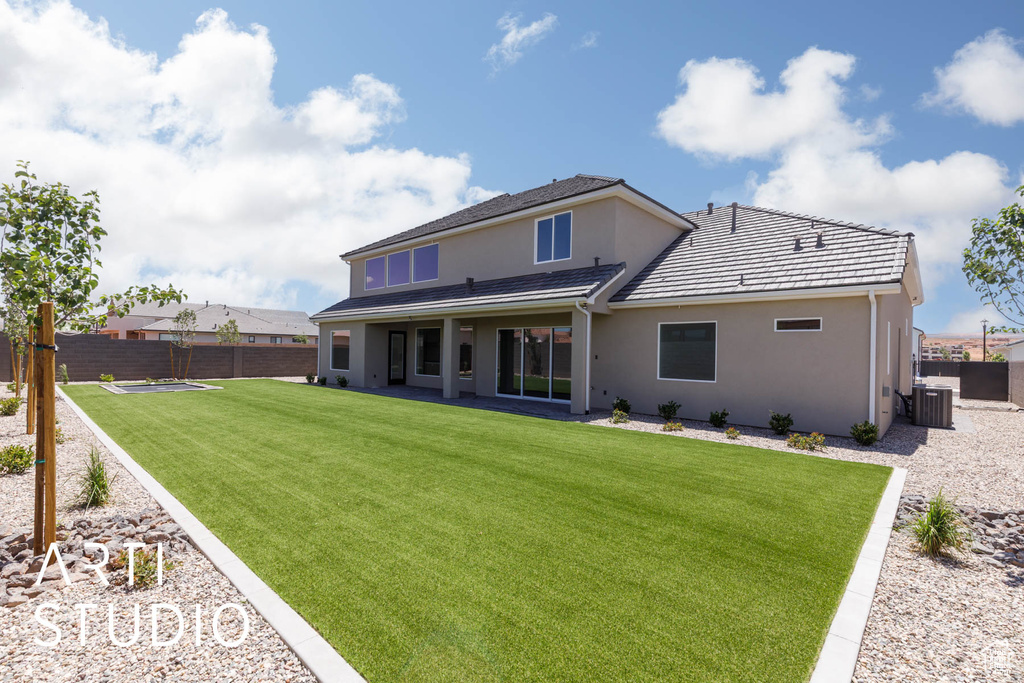 Back of property with central air condition unit, stucco siding, and a patio