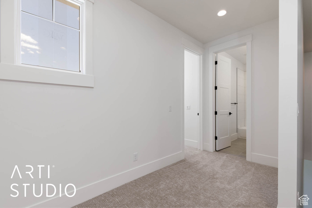 Carpeted empty room with baseboards and recessed lighting