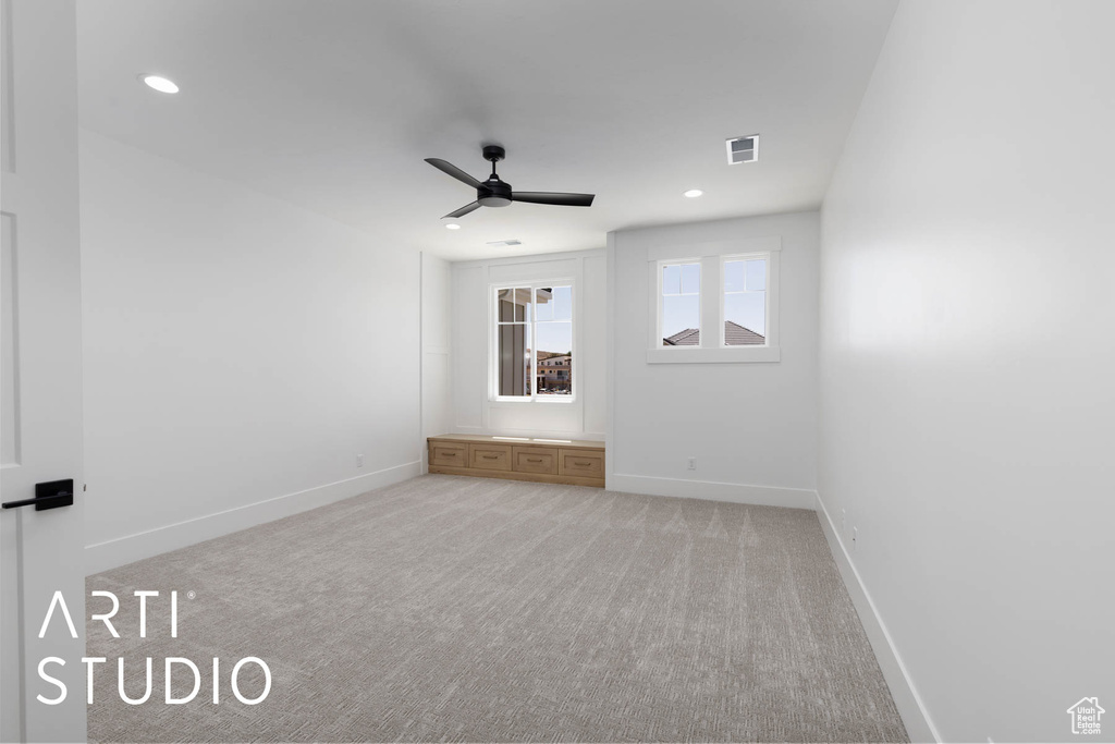 Spare room featuring ceiling fan, baseboards, light carpet, and recessed lighting