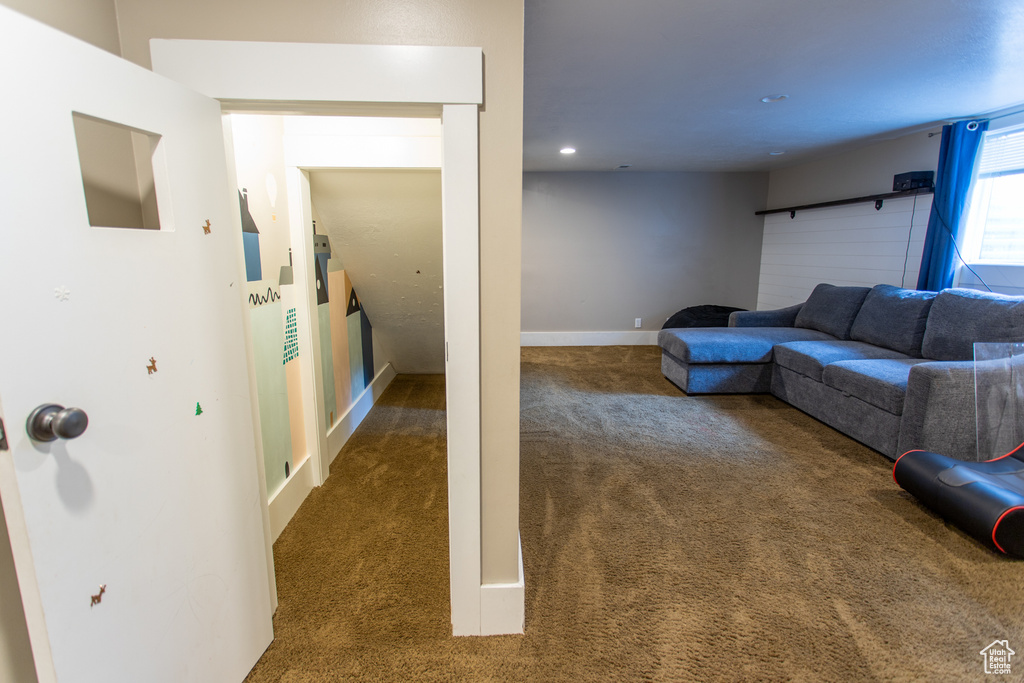 Carpeted living room featuring recessed lighting and baseboards