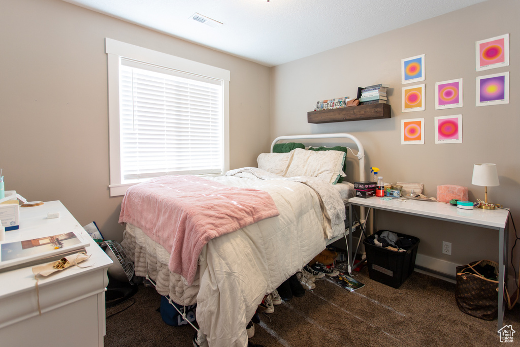 Bedroom with carpet floors and visible vents