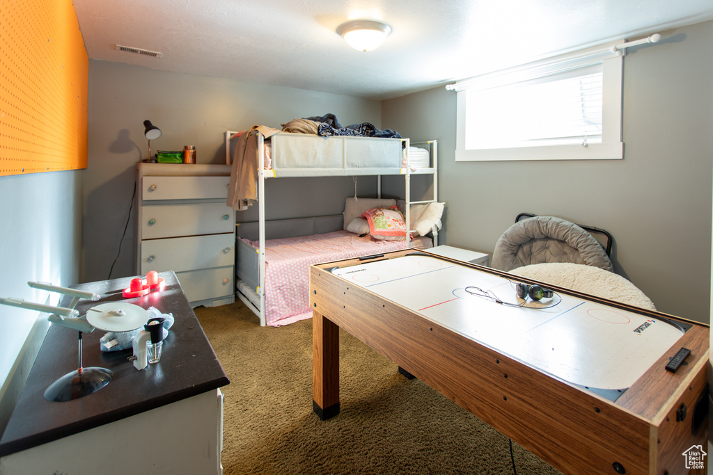 Bedroom with carpet flooring and visible vents