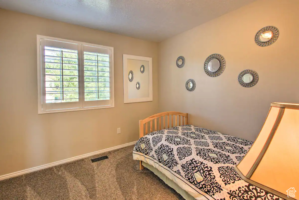 Bedroom featuring carpet, visible vents, and baseboards