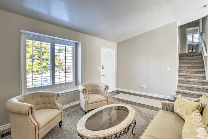 Living room with stairway and baseboards