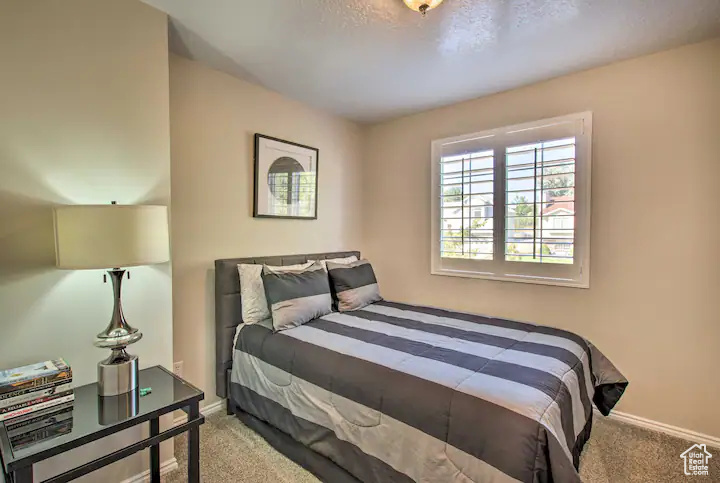 Carpeted bedroom featuring baseboards