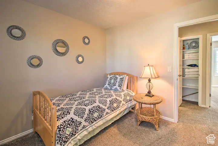 Bedroom featuring carpet floors and baseboards