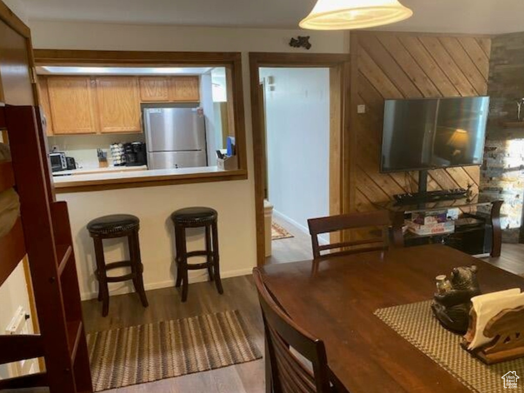 Dining room with baseboards and dark wood-style floors