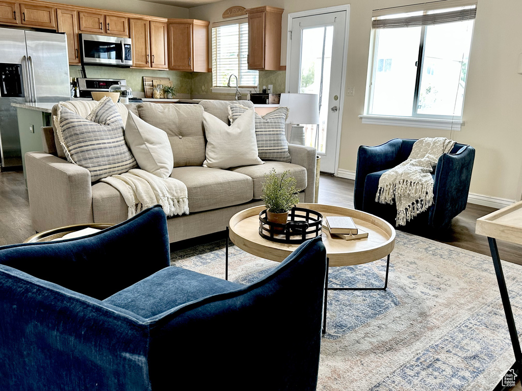 Living room with dark wood-type flooring and baseboards