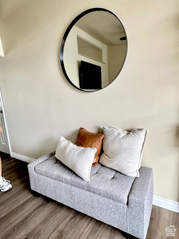 Living area with baseboards and wood finished floors
