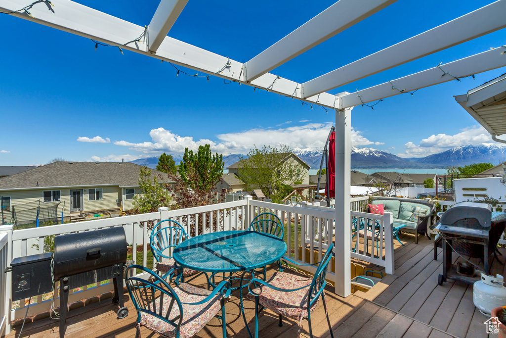 Wooden deck with a mountain view, a residential view, and area for grilling