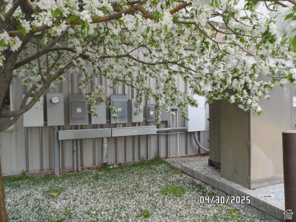 View of yard with fence and electric panel