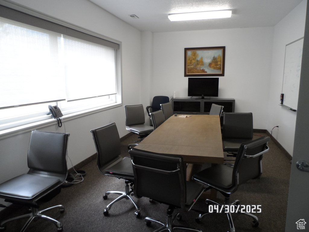 Carpeted office featuring baseboards and visible vents