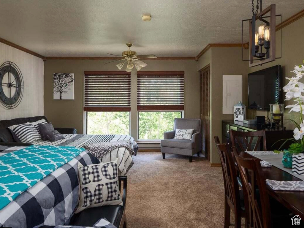 Carpeted bedroom featuring a textured ceiling and crown molding