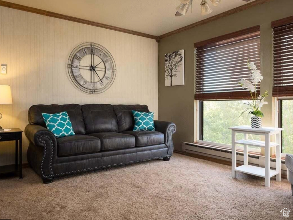 Living room featuring a healthy amount of sunlight, carpet flooring, and ornamental molding
