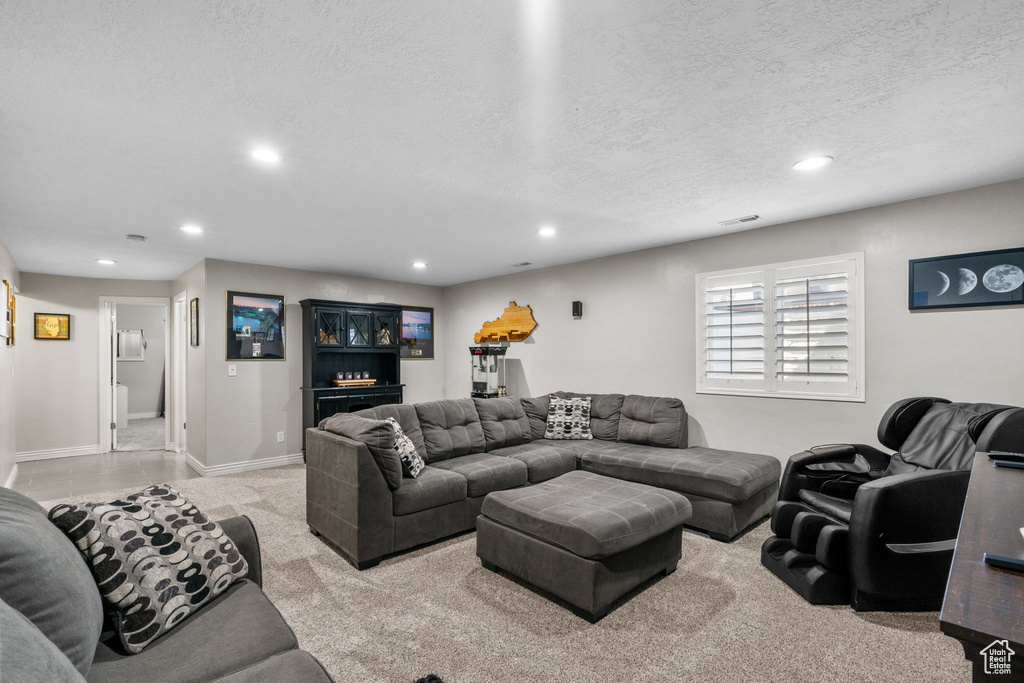 Living area with light carpet, recessed lighting, a textured ceiling, and visible vents