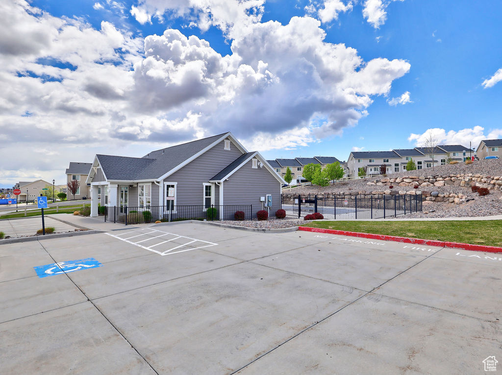 Exterior space featuring a residential view and fence