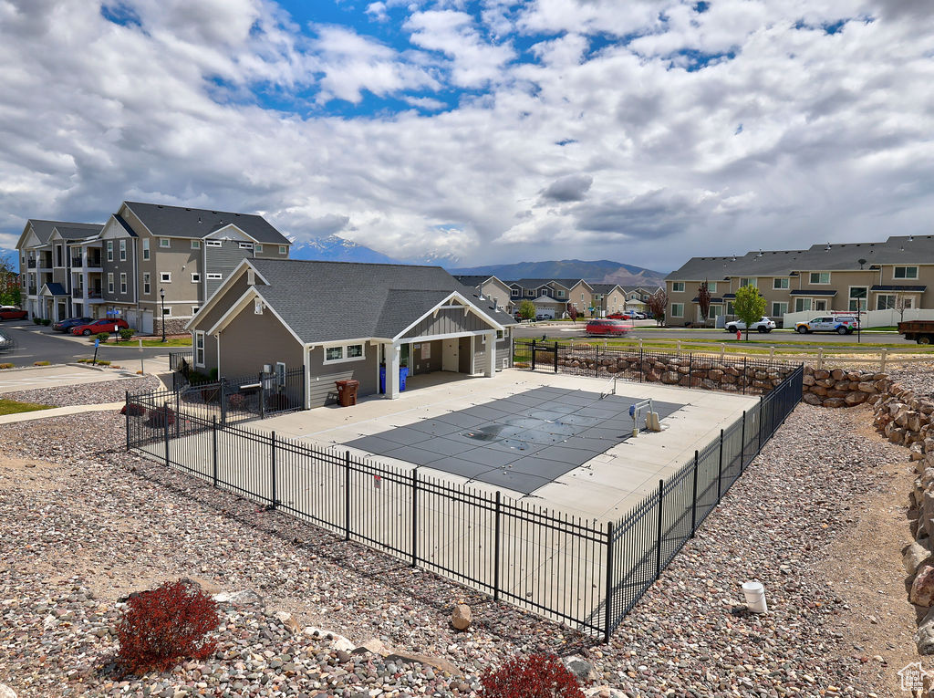 Community pool featuring a residential view, fence, and a patio