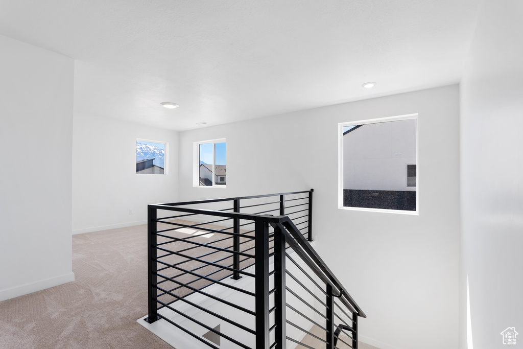 Stairs with recessed lighting, baseboards, and carpet floors
