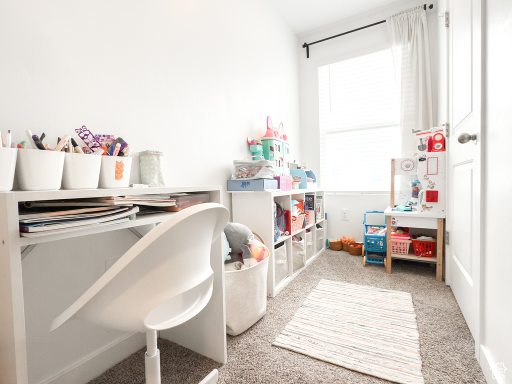 Recreation room with baseboards and carpet