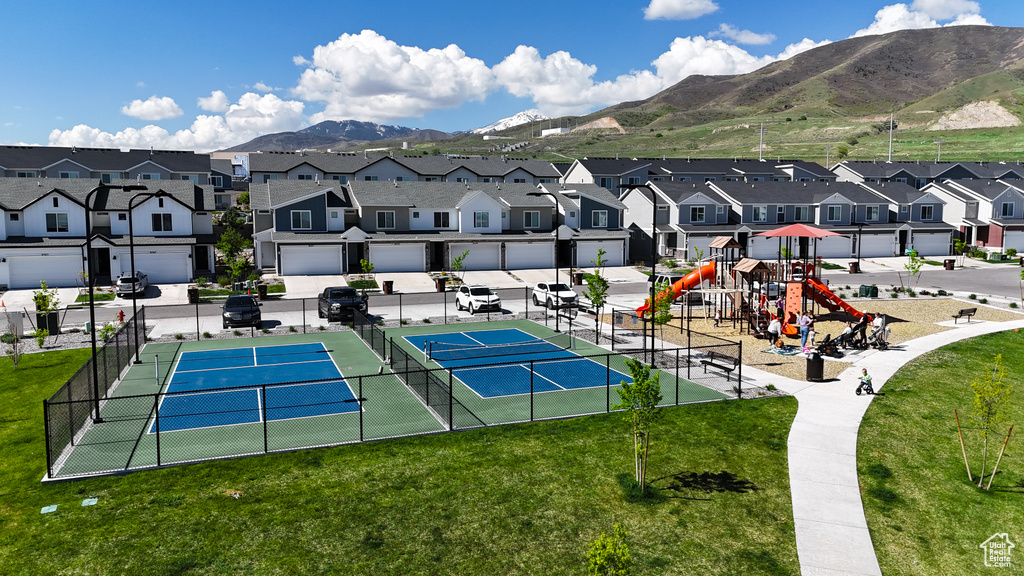 View of sport court with a lawn, a mountain view, playground community, and a residential view
