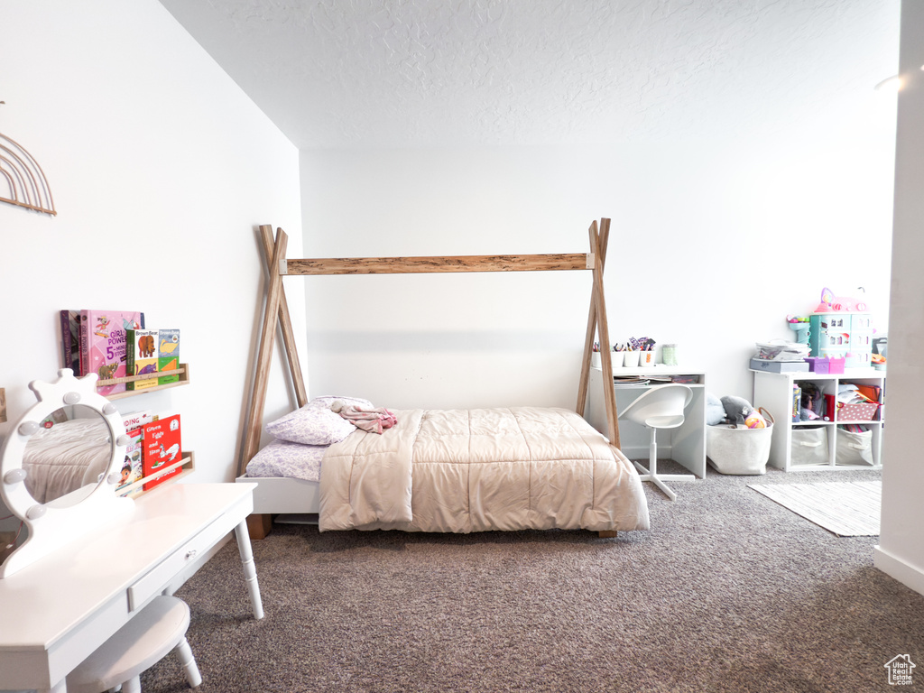 Carpeted bedroom with a textured ceiling