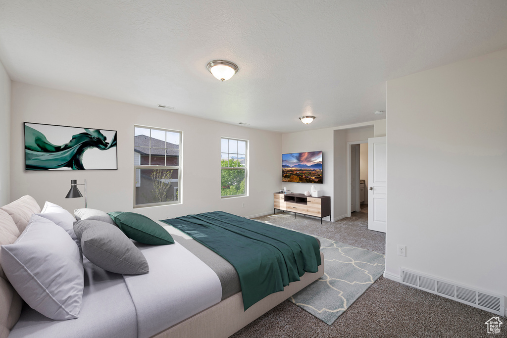Bedroom with baseboards, visible vents, and carpet