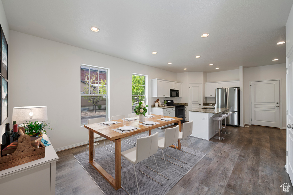 Dining area featuring recessed lighting, baseboards, and dark wood finished floors