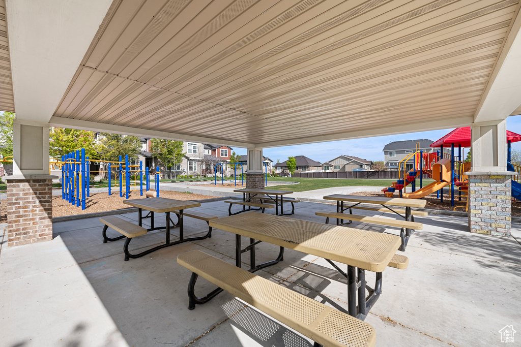 View of patio with fence, playground community, and a residential view