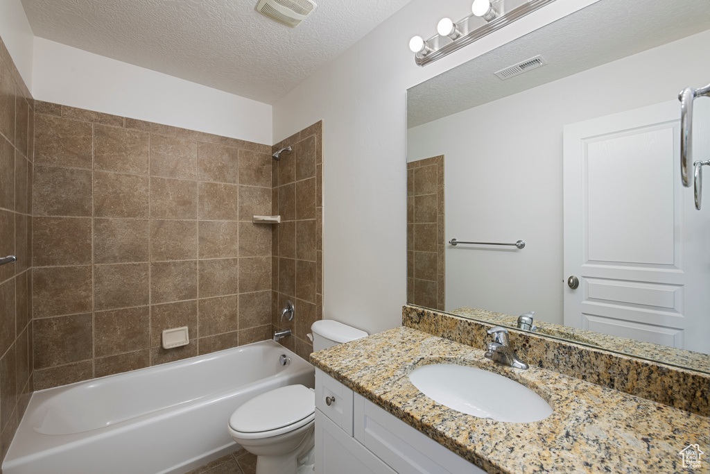 Bathroom with shower / bathing tub combination, visible vents, toilet, and vanity