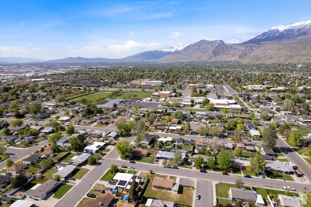 Aerial overview of property's location featuring a mountainous background and nearby suburban area