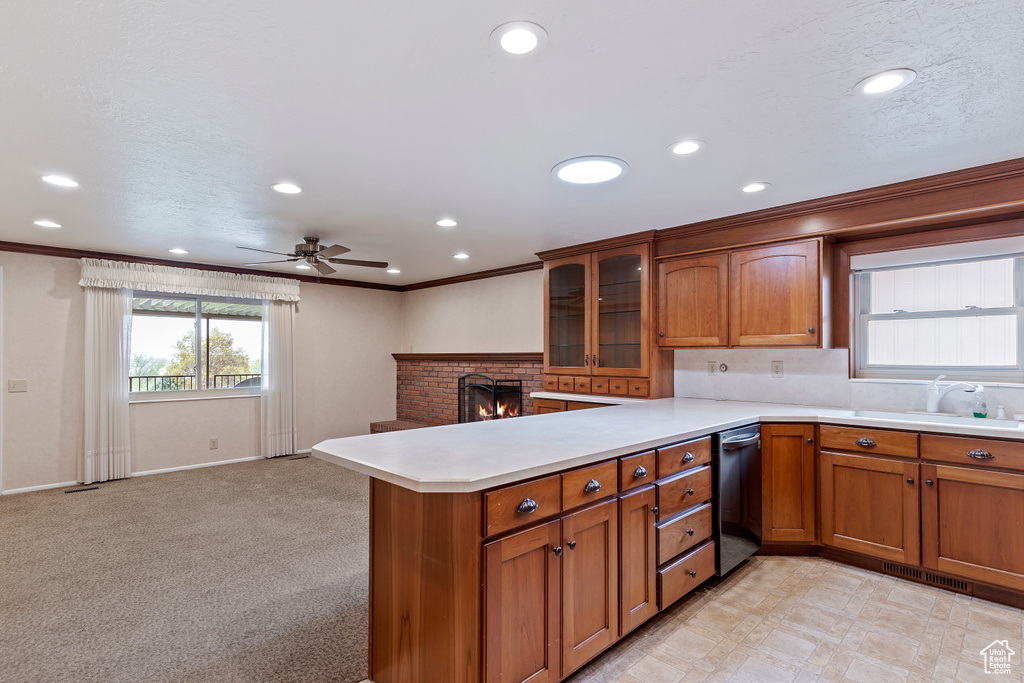 Kitchen featuring a sink, dishwasher, and brown cabinets